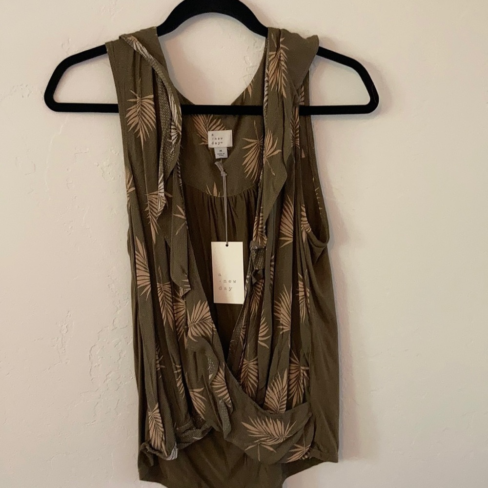 A darling tank top size medium. Brand new with tags still attached.